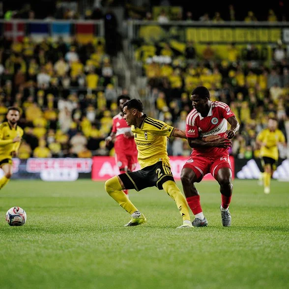 A Columbus Crew player shielding the ball from an opponent