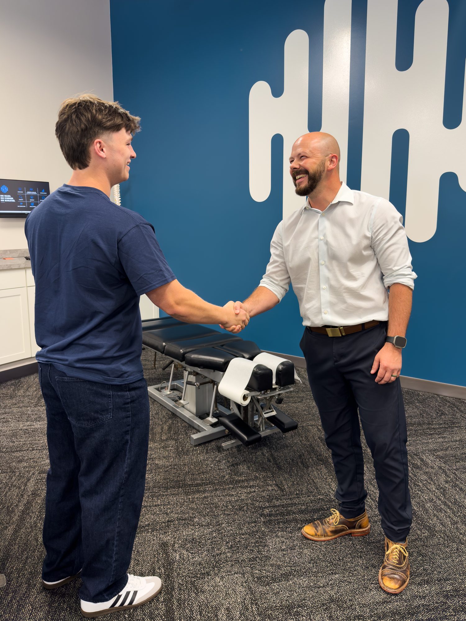 A provider shaking hands at an Ability Chiropractic clinic