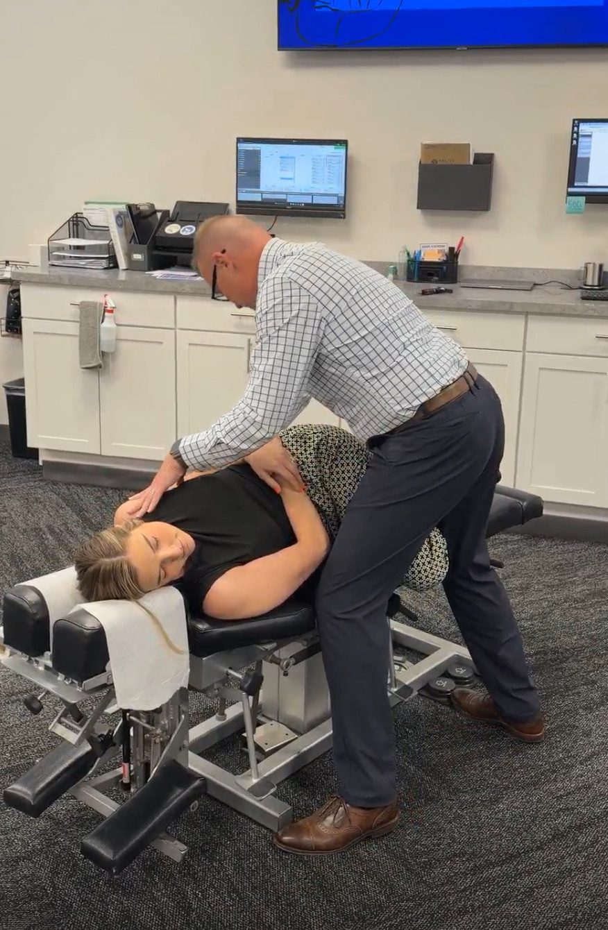 An Ability Chiropractic doctor performing a side-posture adjustment